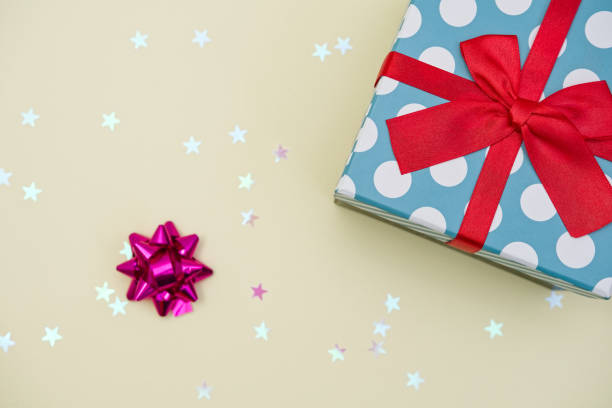 istock Gift box decorated with bright red knotted bow and dotted wrapping paper 2155055047