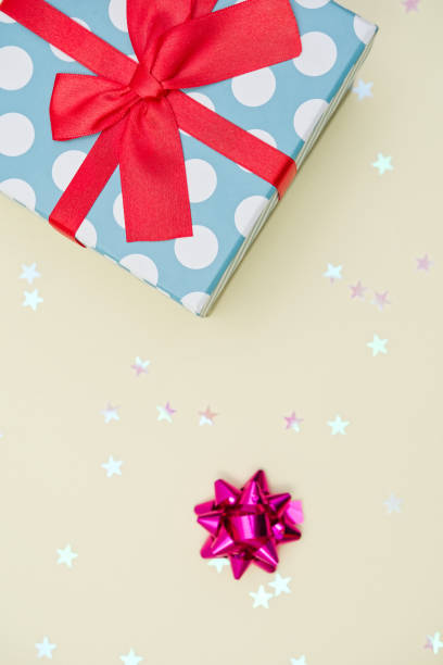 istock Gift box decorated with bright red knotted bow and dotted wrapping paper 2155055052