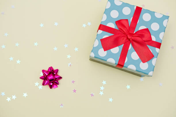 istock Gift box decorated with bright red knotted bow and dotted wrapping paper 2155055054
