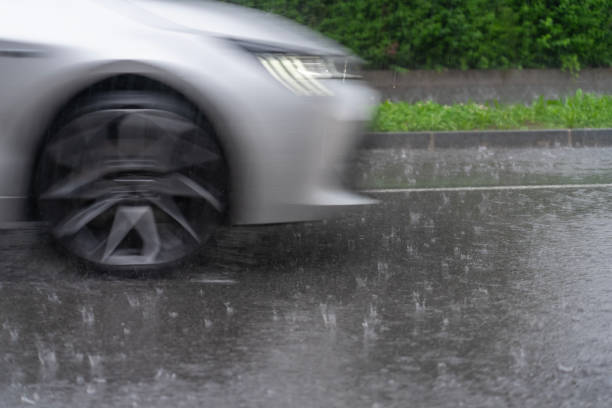 istock Front part of a car on asphalt road in rain 2155055733