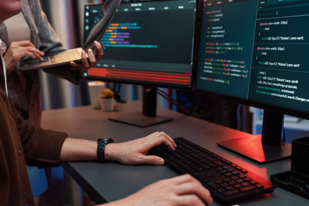 istock IT developers discussing intelligent website with laptop showing data. Infobahn. 2155055816