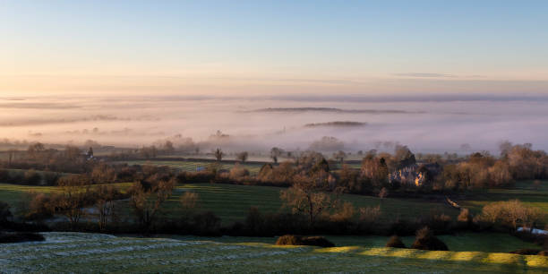istock Winter sunset in a misty rural valley 2155059933