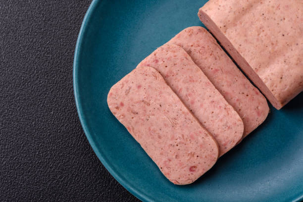 Delicious canned pink ham with salt, spices and herbs