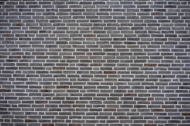 Gray brick wall texture perfect for backgrounds or copy space in design projects.
