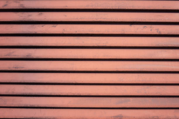 Texture of rust red diagonal symmetrical slats.