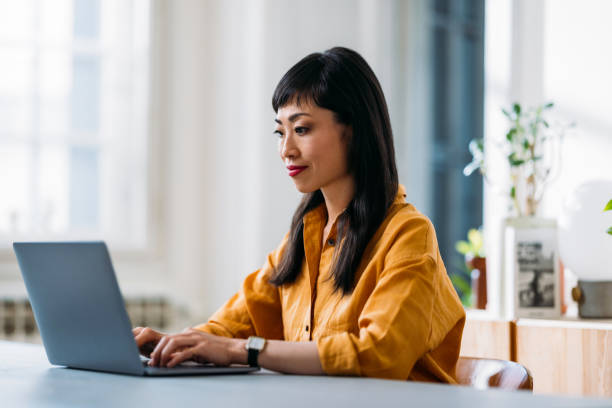 istock Focused Woman Working on Laptop in Modern Office 2155064701