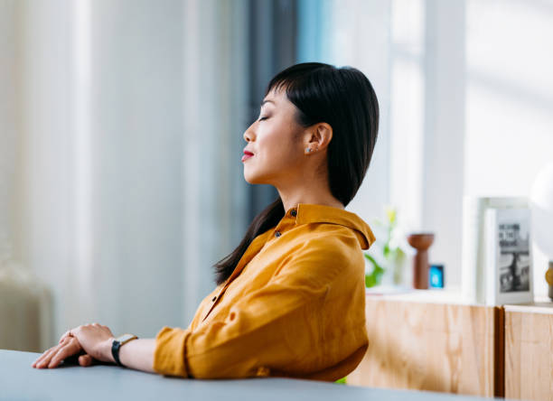 Woman Relaxing with Eyes Closed in Office Environment