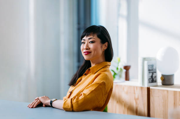 istock Confident Woman Sitting in Modern Office Environment 2155064745
