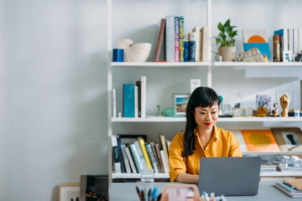 istock Focused Woman Working on Laptop in Modern Office 2155064806
