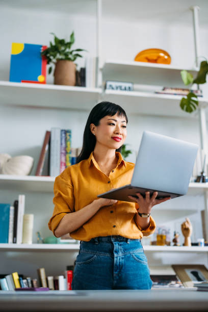 istock Woman Working on Laptop in Modern Home Office 2155064822