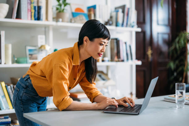 istock Focused Woman Working on Laptop in Home Office 2155064825