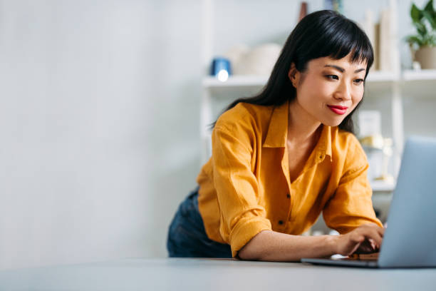 istock Confident Woman Working on Laptop in Modern Home Office 2155064865