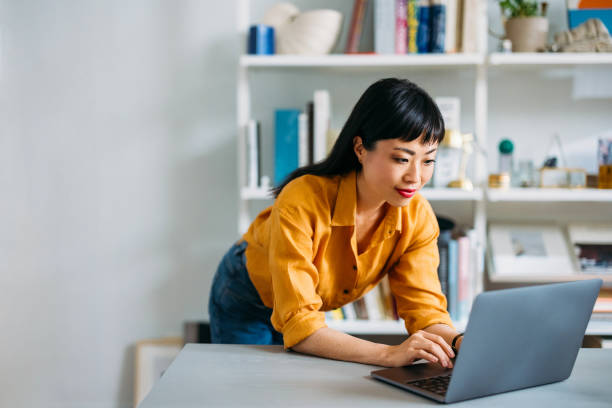 Woman Working on Laptop in Modern Home Office Setting