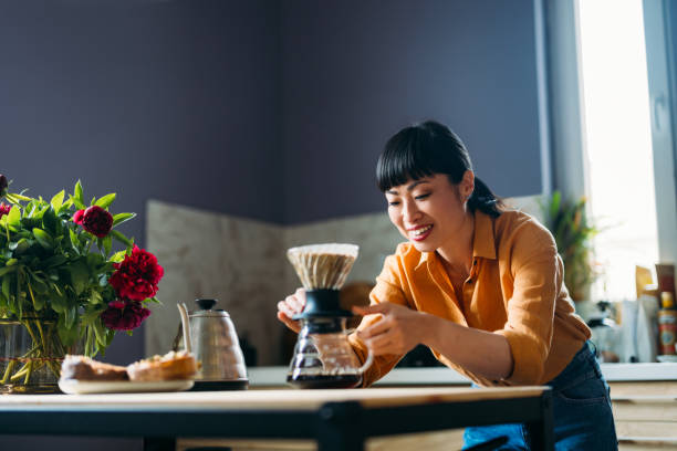 istock Woman Brewing Coffee Using Pour Over Method at Home 2155064910