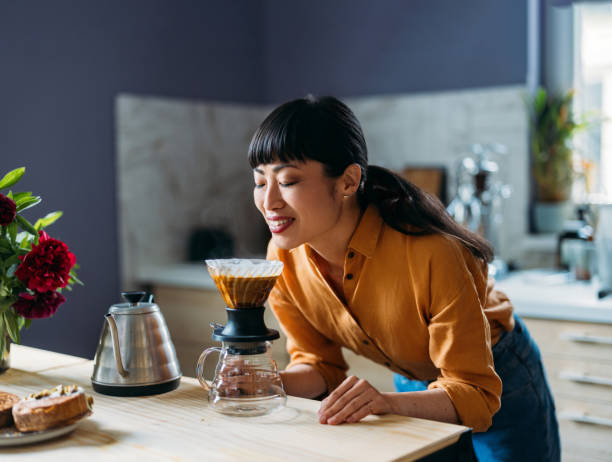 istock Woman Enjoying Freshly Brewed Coffee in Cozy Kitchen 2155064937