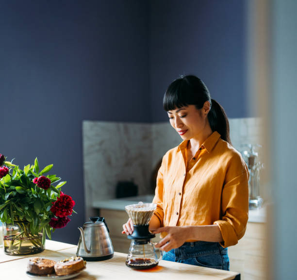 Woman Making Pour Over Coffee in Modern Kitchen