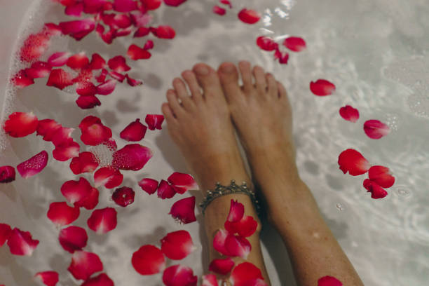 istock feet and petals in the water during a romantic celebration 2155065432