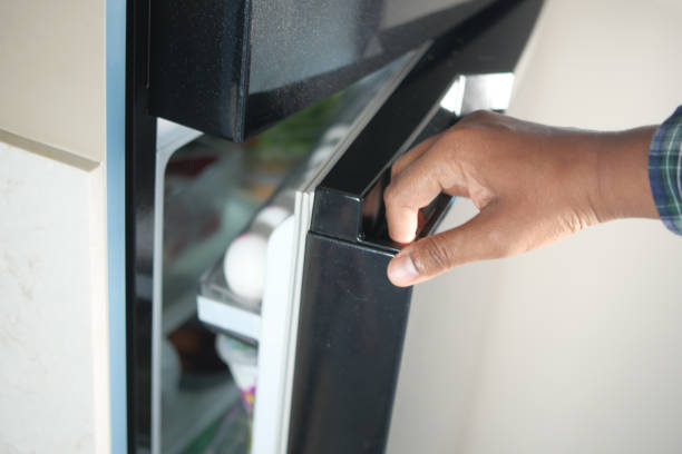 istock half open fridge with food and vegetables , 2155065487