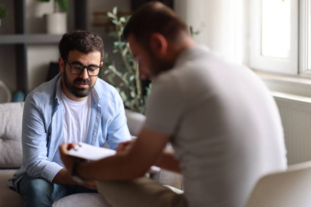 istock Doctor talks with patient and takes notes 2155065660