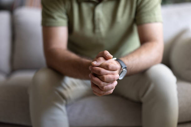 istock Man sitting alone at home looking sad and distraught 2155065844