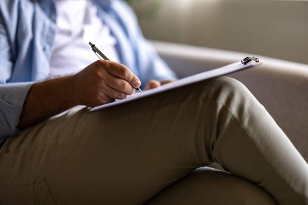 istock Doctor talks with patient and takes notes 2155066039