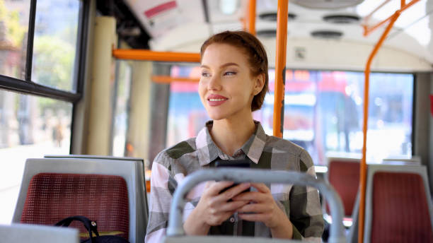 istock Young businesswoman having fun online while riding in a bus 2155066128