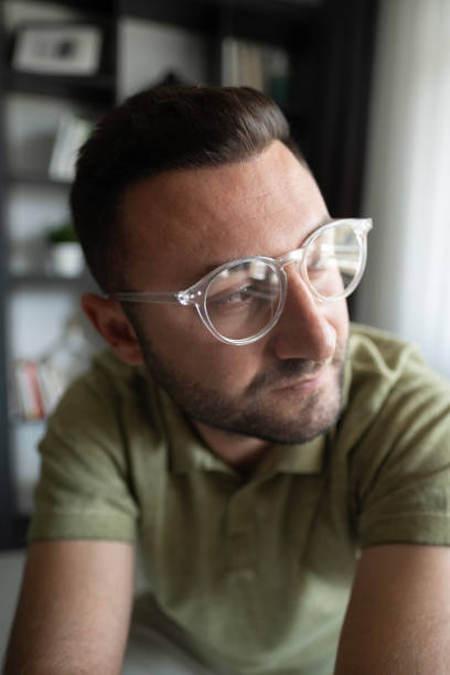 istock Man looking through the window at home 2155066733