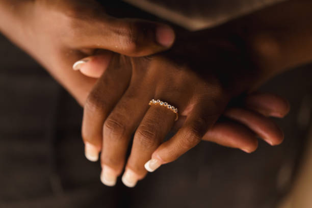 istock a couple of black hands showing wedding ring 2155072786