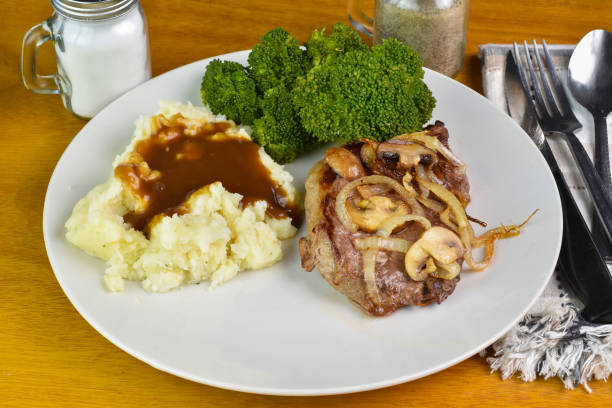 istock steak top with onions and mushrooms  with mash potatoes 2155074183