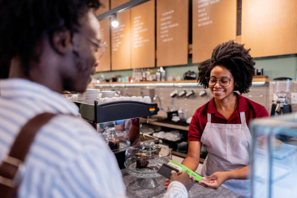 istock Customer buying using credit card to young waitress at cafeteria 2155074392