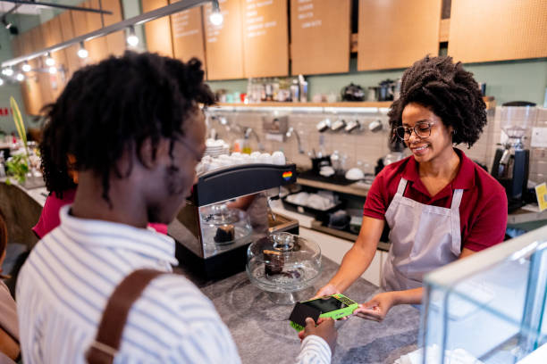 istock Customer buying using credit card to young waitress at cafeteria 2155074396