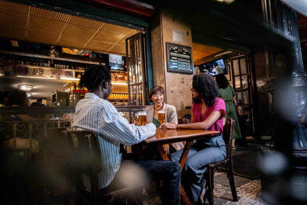 istock Coworkers talking and drinking beer on happy hour at bar 2155074512