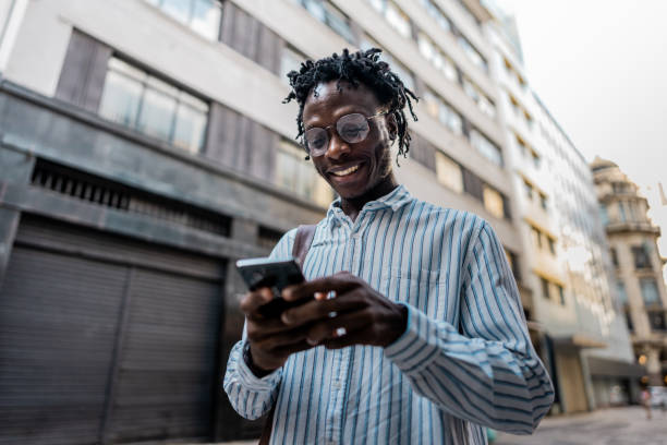 Businessman using mobile phone on the city