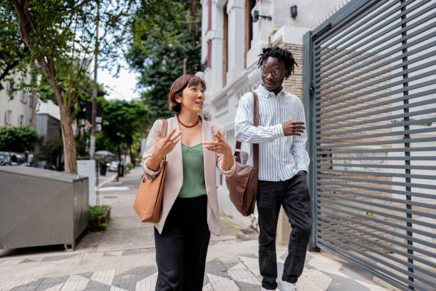 istock Coworkers talking and walking on the city 2155074725