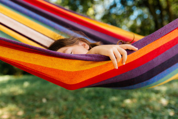 istock Girl resting and daydreaming in a hammock 2155075183