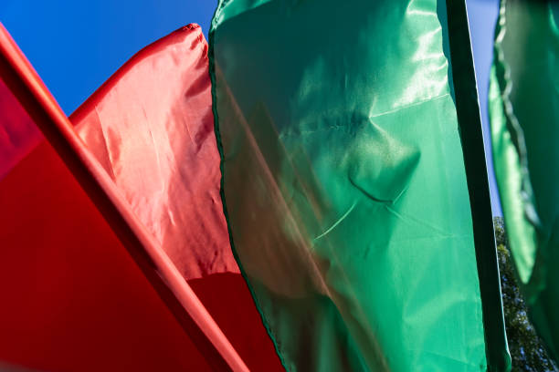 green flags set up during the celebration in windy weather, flags flutter in the wind in spring