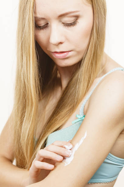 istock Woman apply moisturizer cream on her body 2155077407