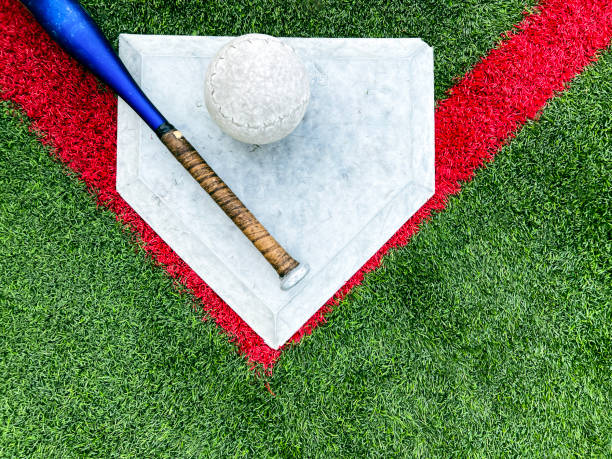 istock Softball Equipment on Green Turf Field with Red Lines 2155077608