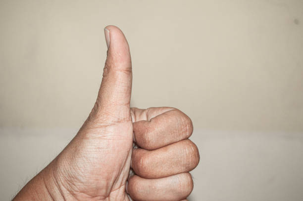 Woman showing a thumbs up on white
