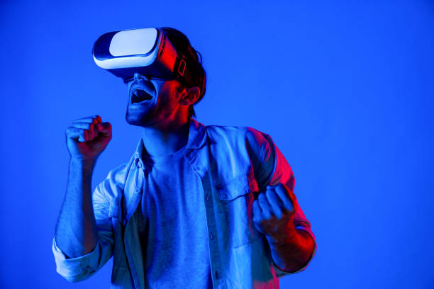 istock Caucasian man singing a song in virtual world at neon background. Deviation. 2155081595