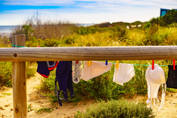 Camping on beach, adventure concept. Clothes clean washing laundry hanging to dry on clothesline outdoor on beach.