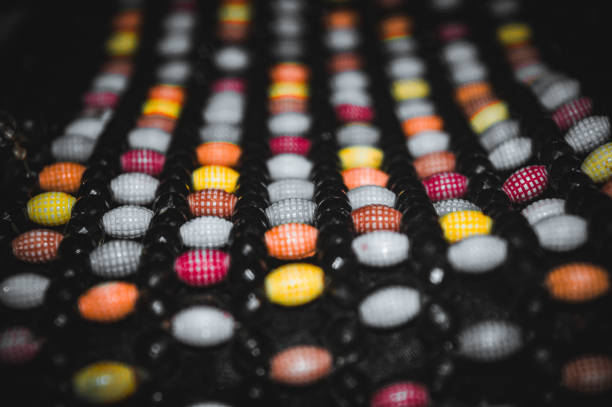 colorful mote berry beads attached to a women's bag