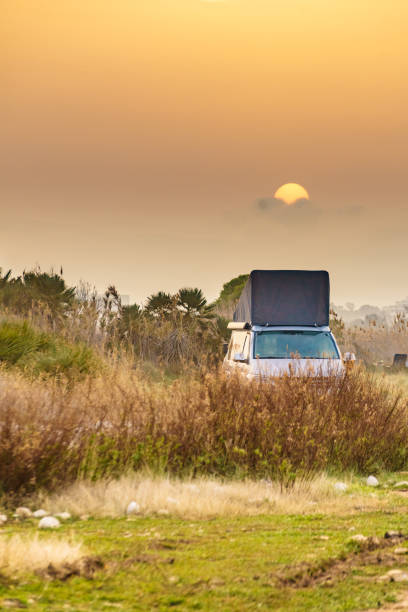 istock Camper van with roof top tent camp on nature 2155082709