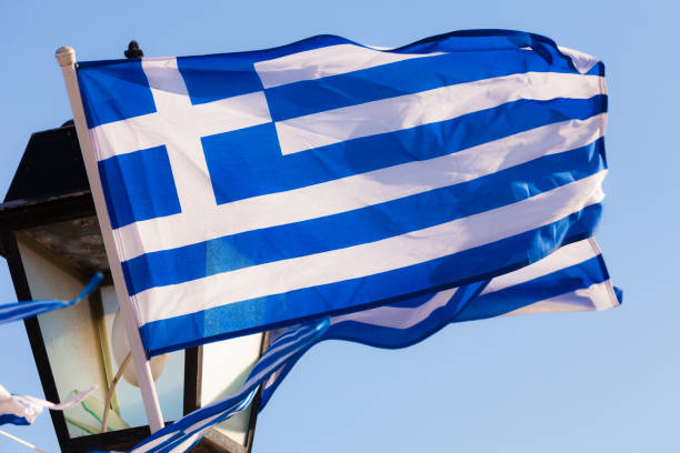 istock Greek flags waving outdoor 2155082844