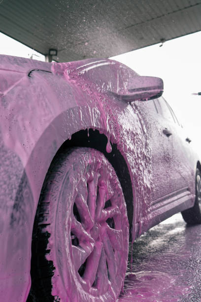 istock Hand washing car with pink foam, advertising 2155083928