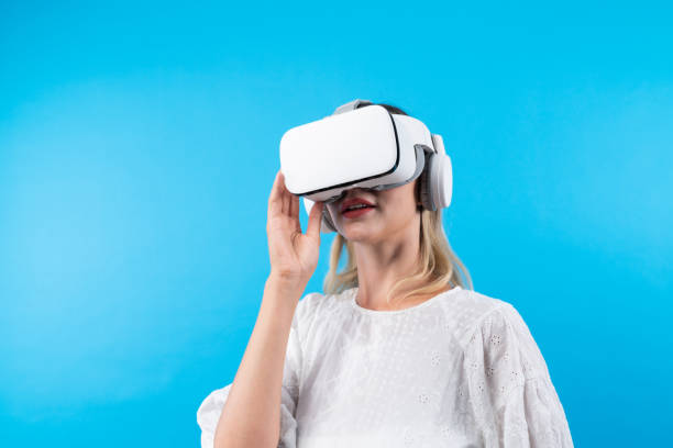 istock Happy woman surprised or excited while looking though VR glasses. Contraption. 2155084796