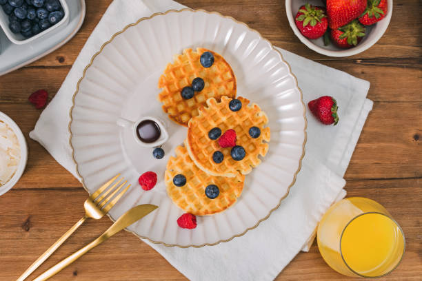 istock Breakfast with waffles and berries on the wooden table, top view 2155085070