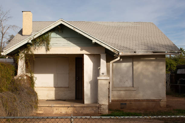 istock Empty abandoned house with boarded up windows 2155087684
