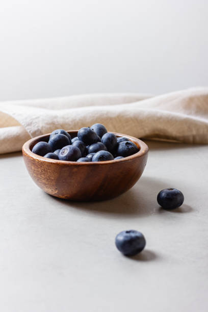 istock Blueberries in a wooden bowl 2155089094