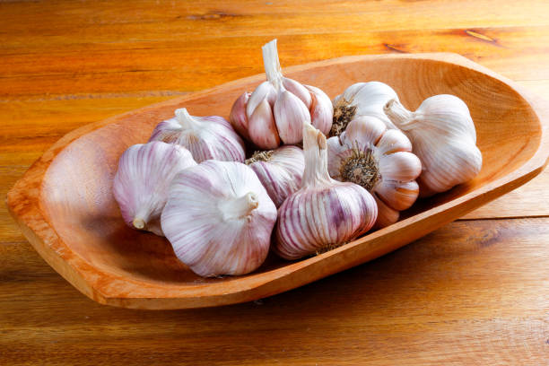 istock Close Up Raw, Fresh Garlic Cloves and Bulbs on Rustic bowl Wooden Table 2155090129